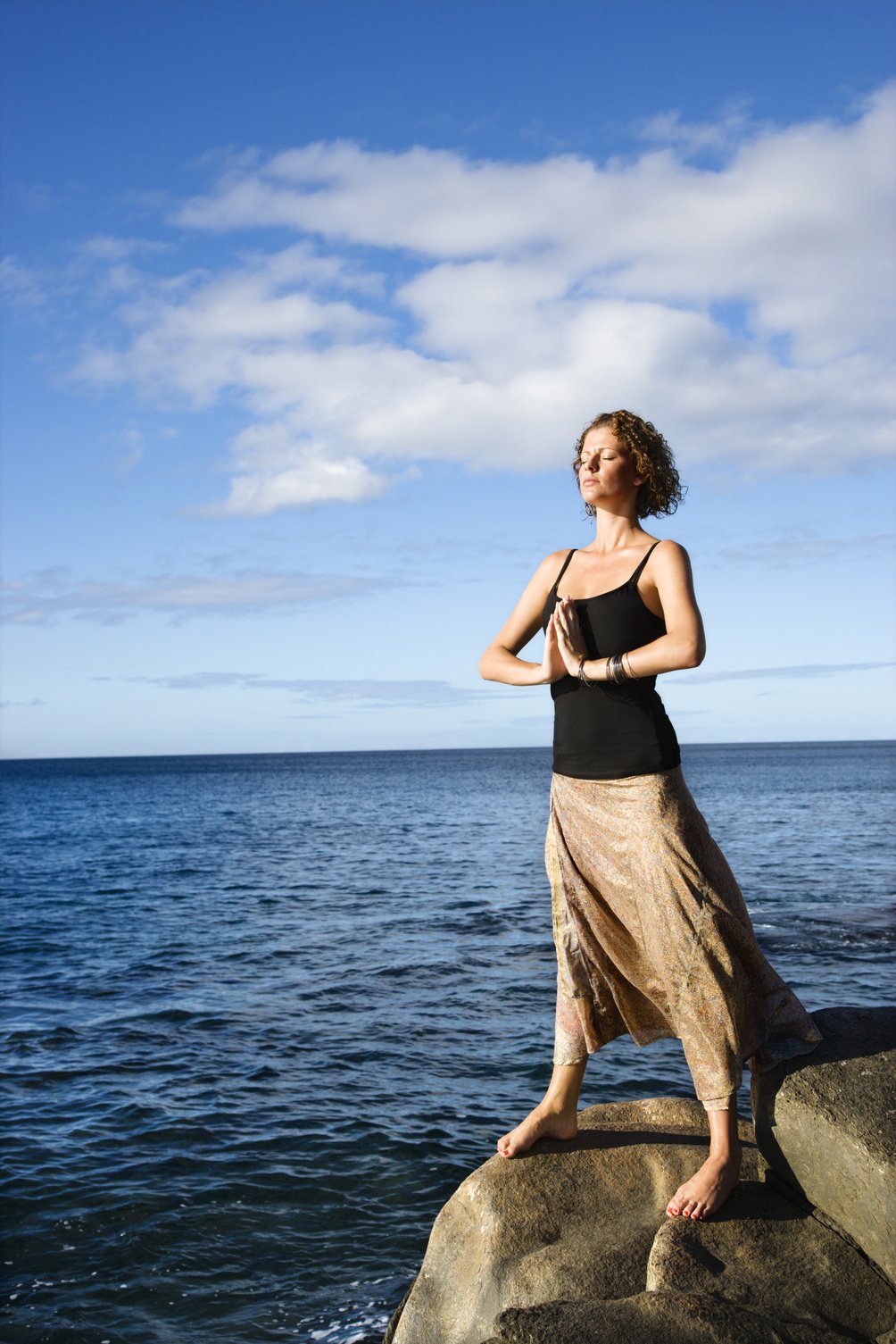 Woman Meditating by Ocean.