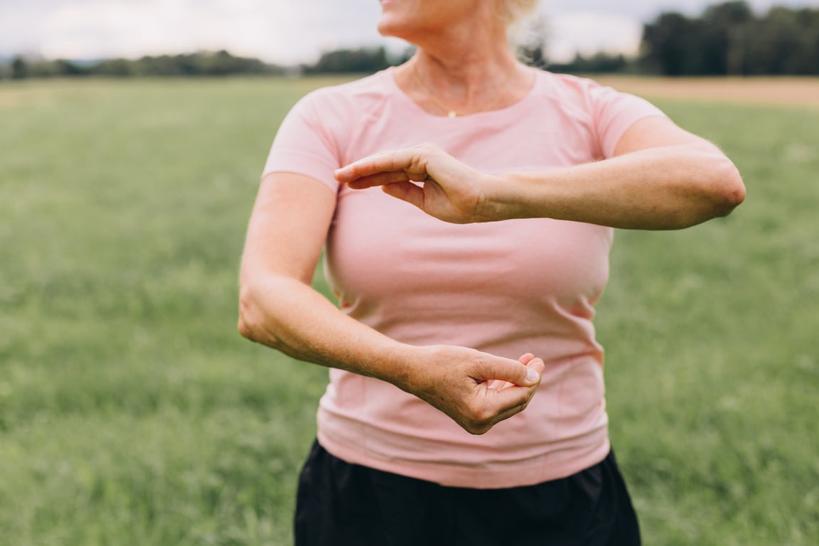 Elderly Woman Doing Tai Chi Outdoors